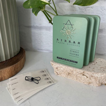 Forest Floors Paper Incense green tin and 48 paper incense strips. Natural musk & sandalwood with herbs & jasmine. Elevate meditation and intention setting rituals. Clean burn, 100% natural.